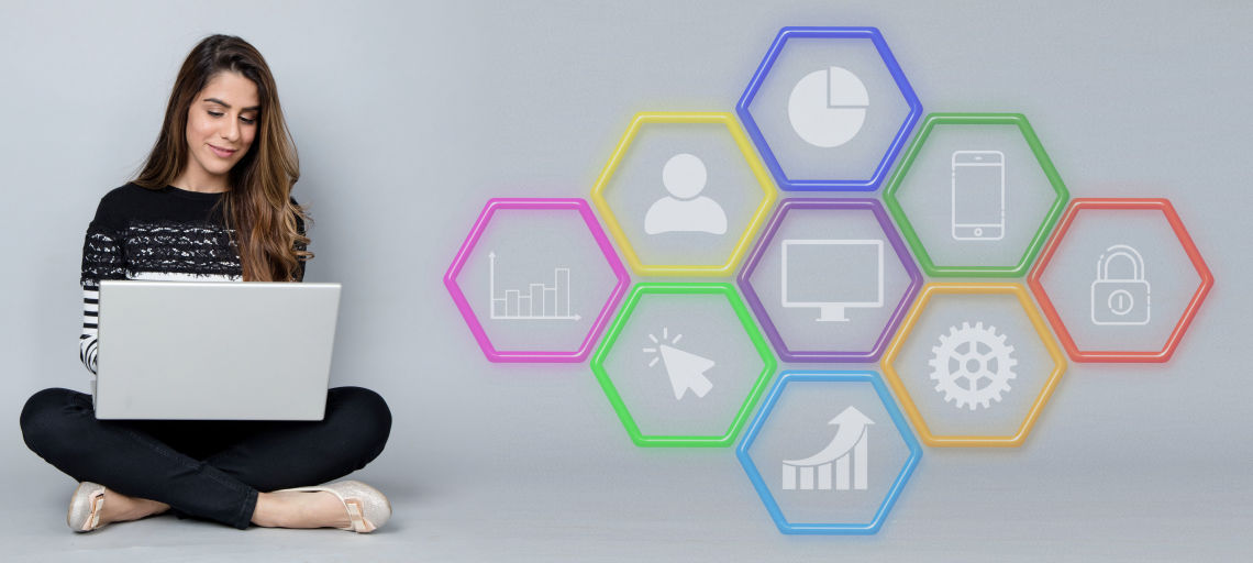 A lady sits with her laptop beside digital icons