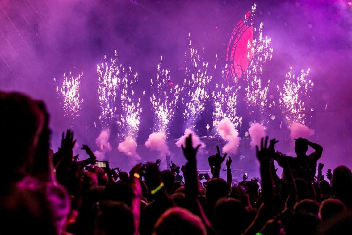 People celebrating in a nightclub with fireworks