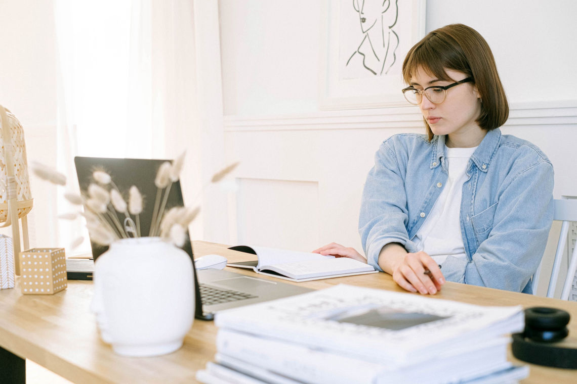 A woman looking at her laptop