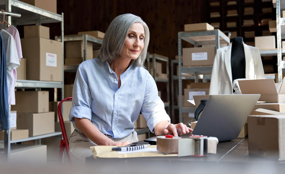 Lady at a desk looking at a lap top